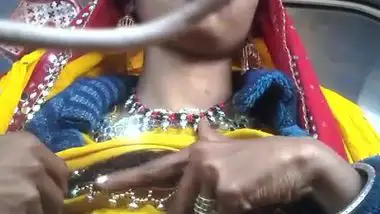 Desi chick pulls her bright dress up to demonstrate big XXX boobs