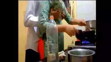 indian new married couple romance in kitchen.