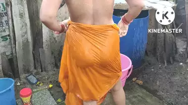 Indian house wife bathing outside